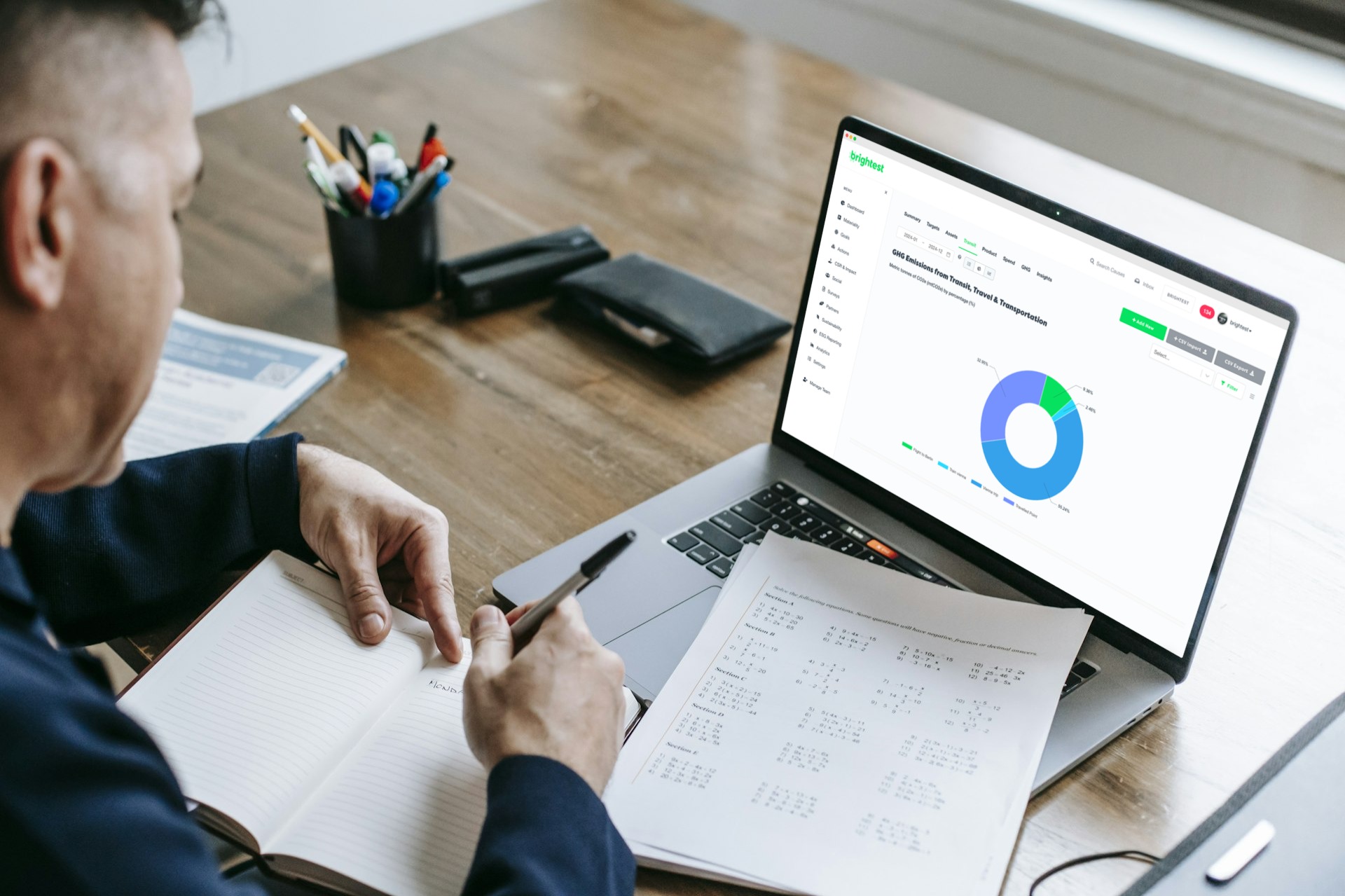 Employee Calculating GHG Emissions Stock Image
